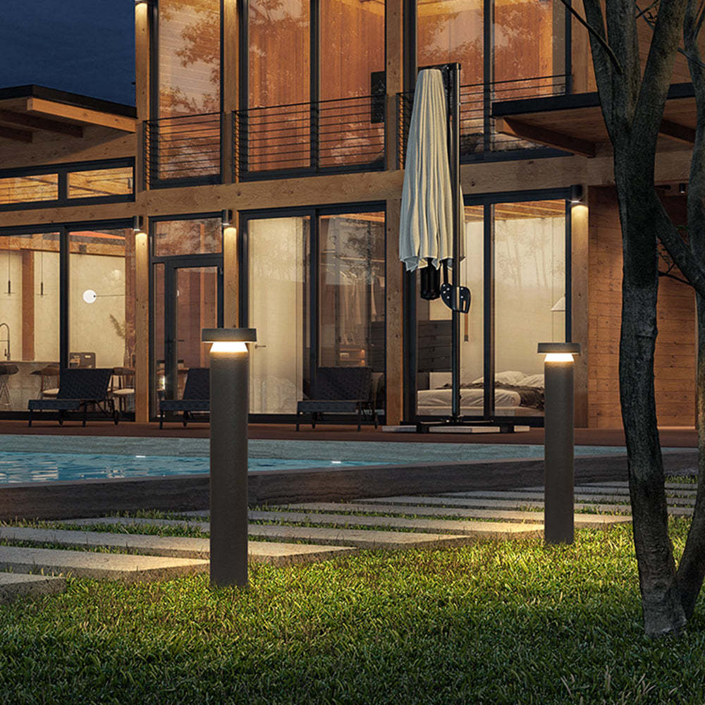 Modern outdoor path lights illuminate a luxury home