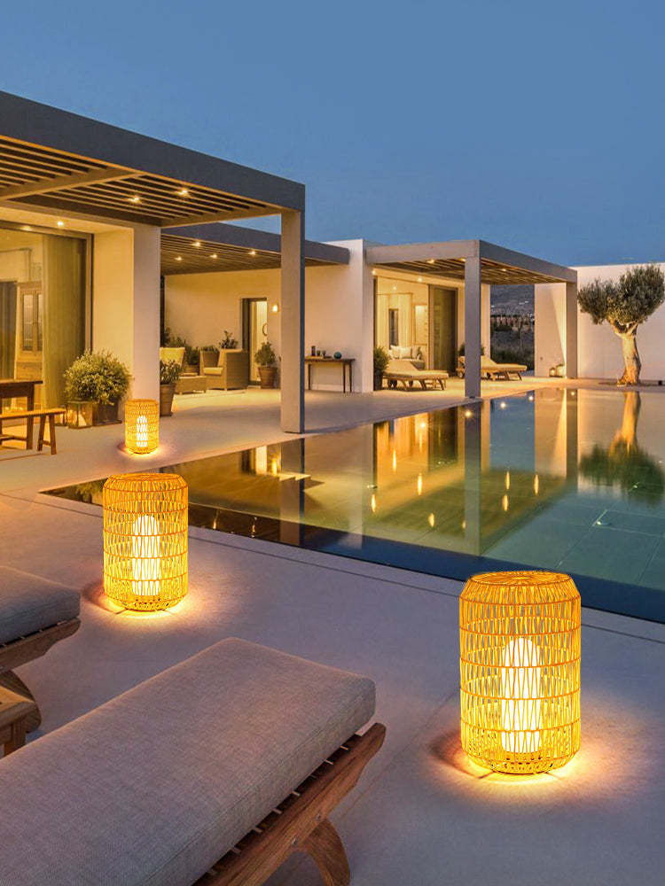 Ritta Rattan Floor Lamps illuminating a modern patio at night