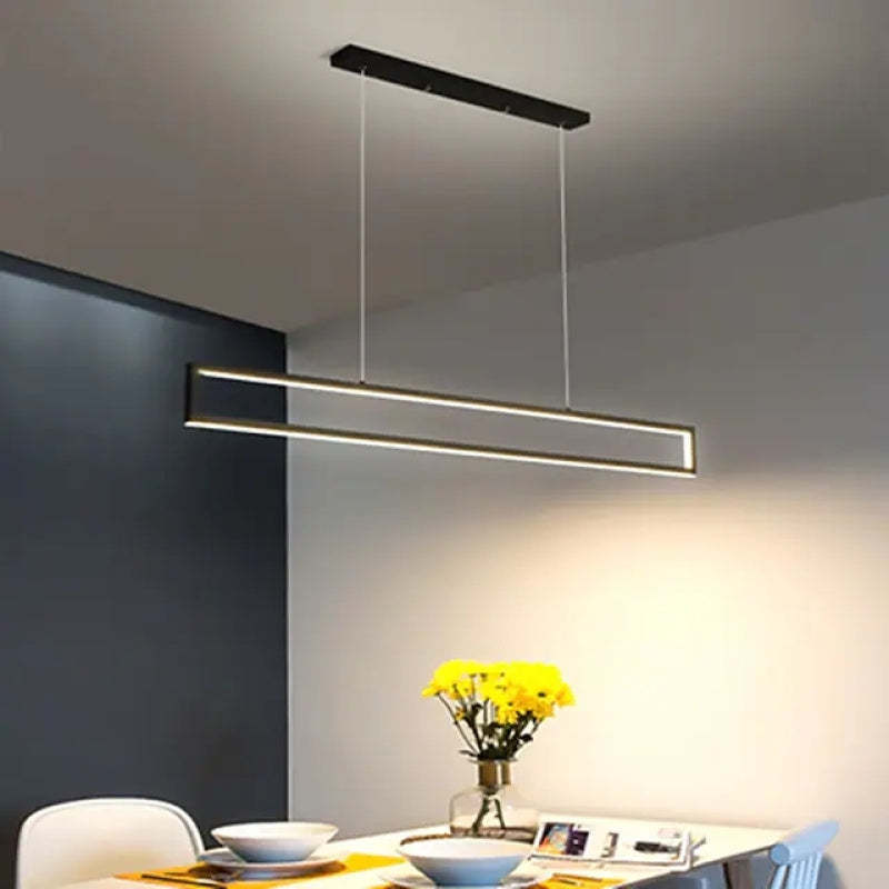 Rectangular LED pendant light over dining table.