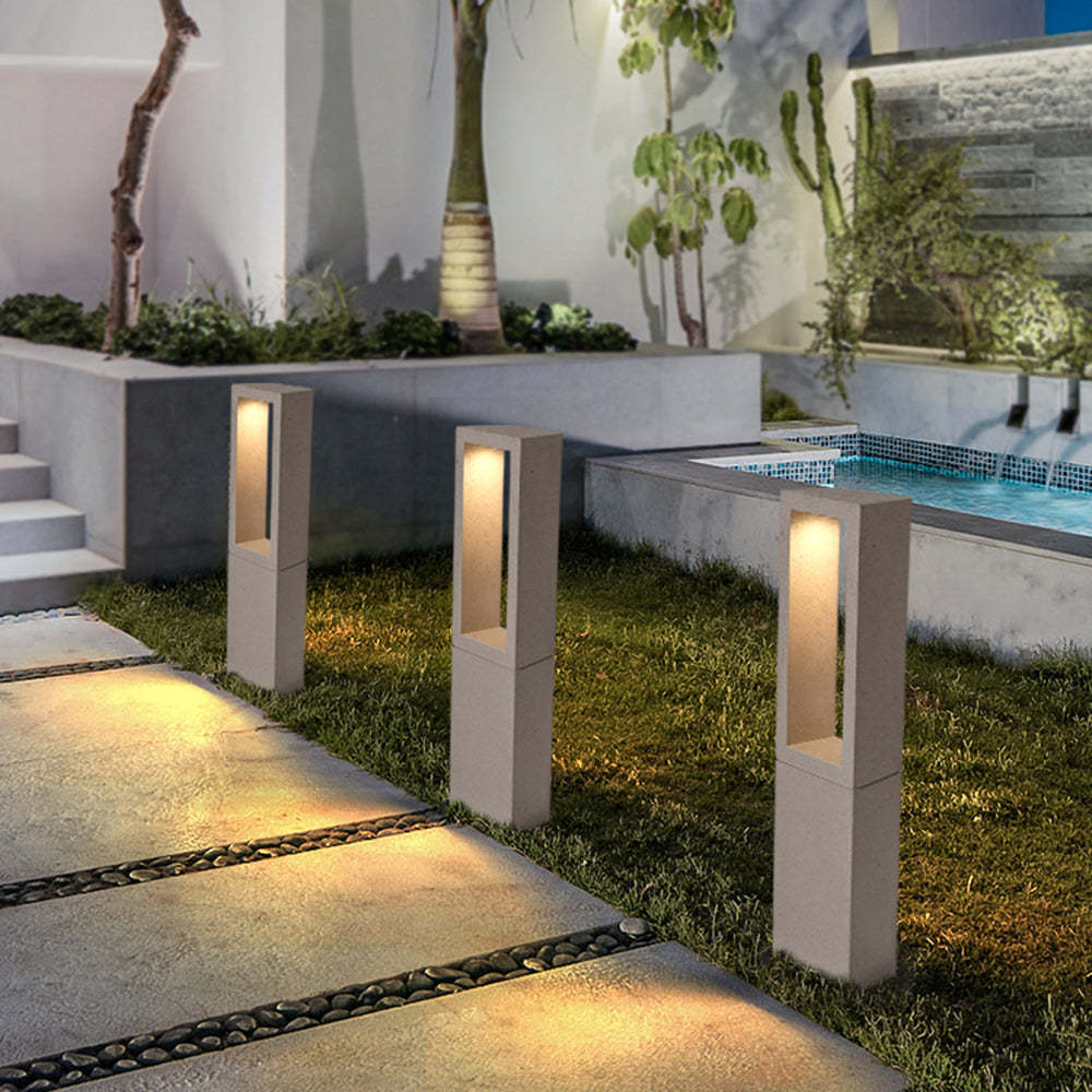 Pena Modern Path Lights illuminate a modern garden walkway