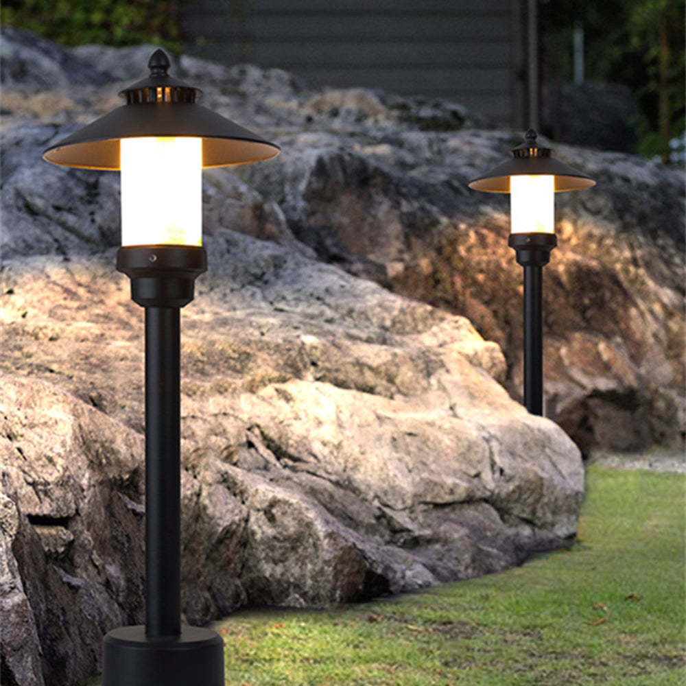 Carins outdoor path lights illuminating a garden at dusk