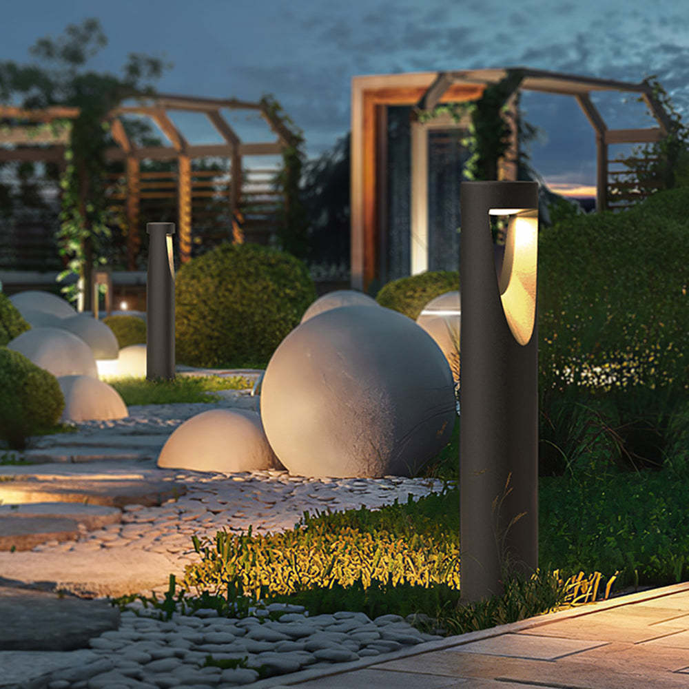 Pena Outdoor Path Light illuminating a garden at dusk
