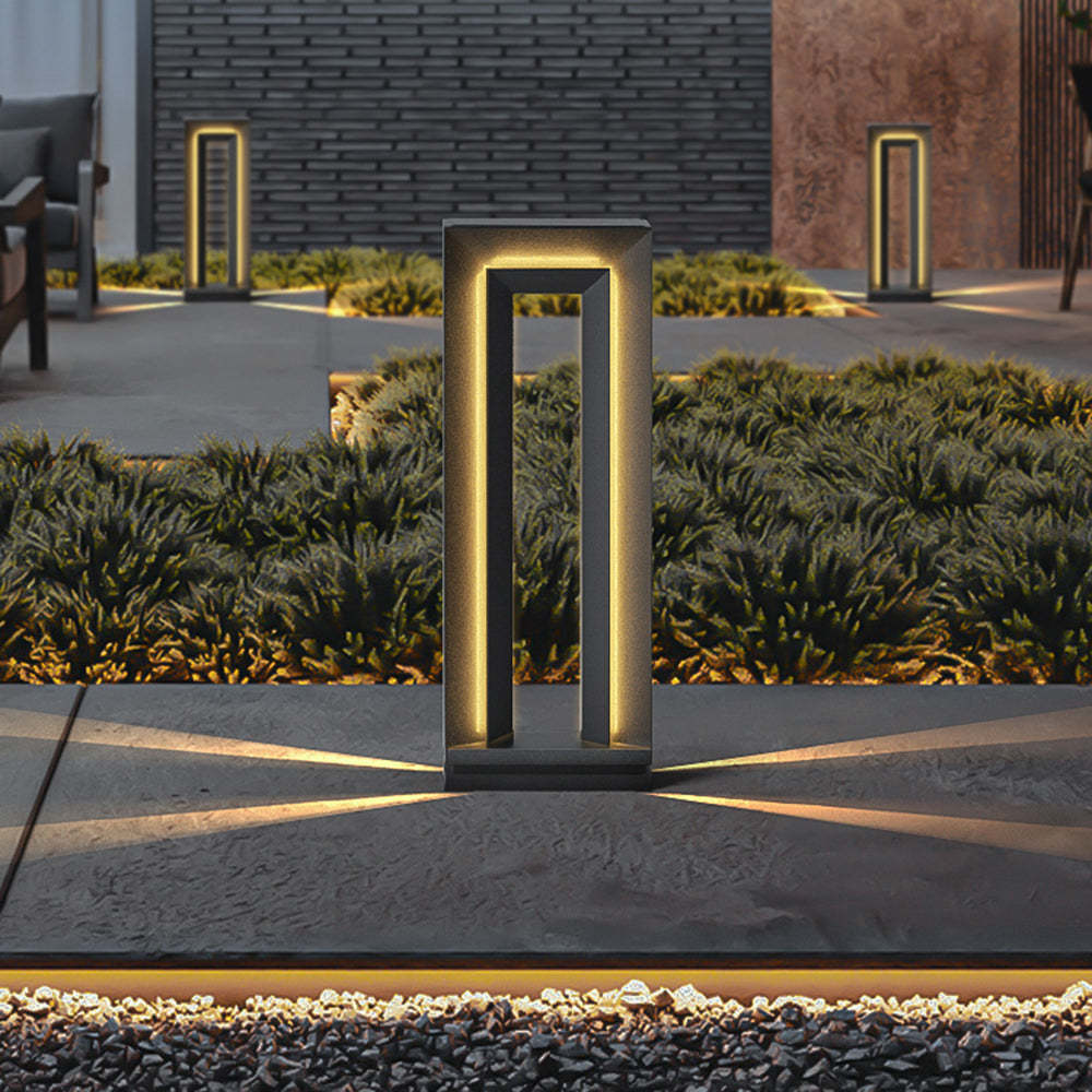 Pena Modern Metal Outdoor Path Light illuminating garden at night