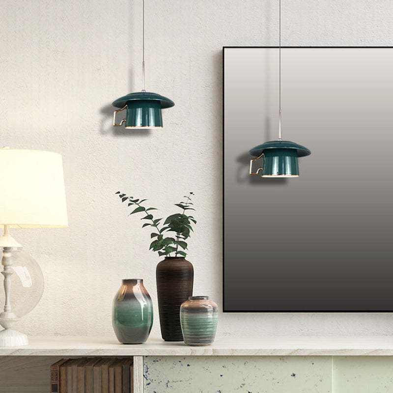 Green ceramic pendant light over a table
