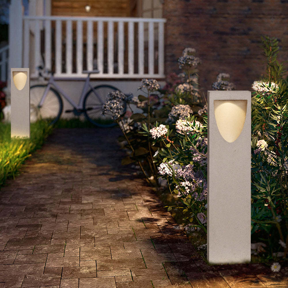 Pena Stone Path Light illuminating pathway, modern outdoor lighting