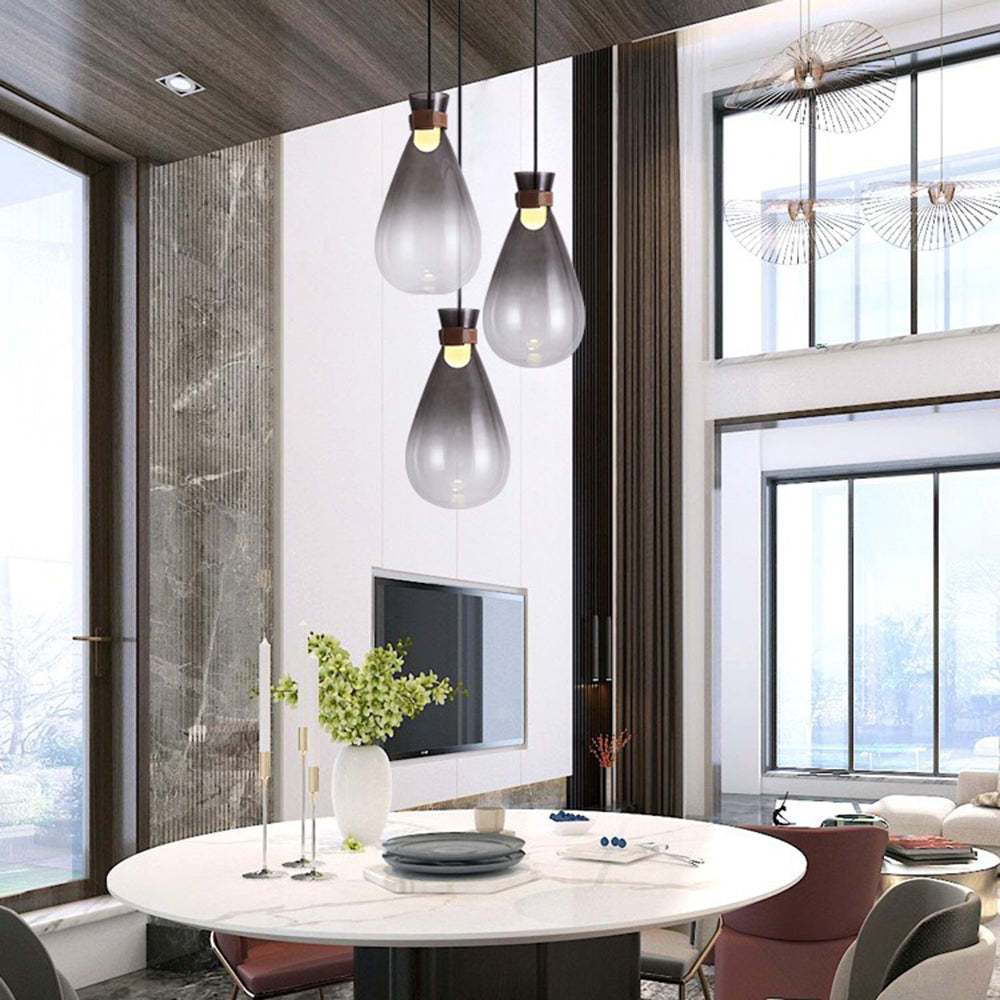 Smoke gray pendant lights over modern dining table