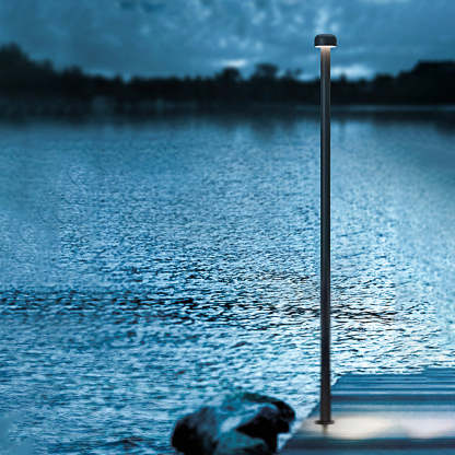 Orr Outdoor Path Light illuminating a lake at dusk