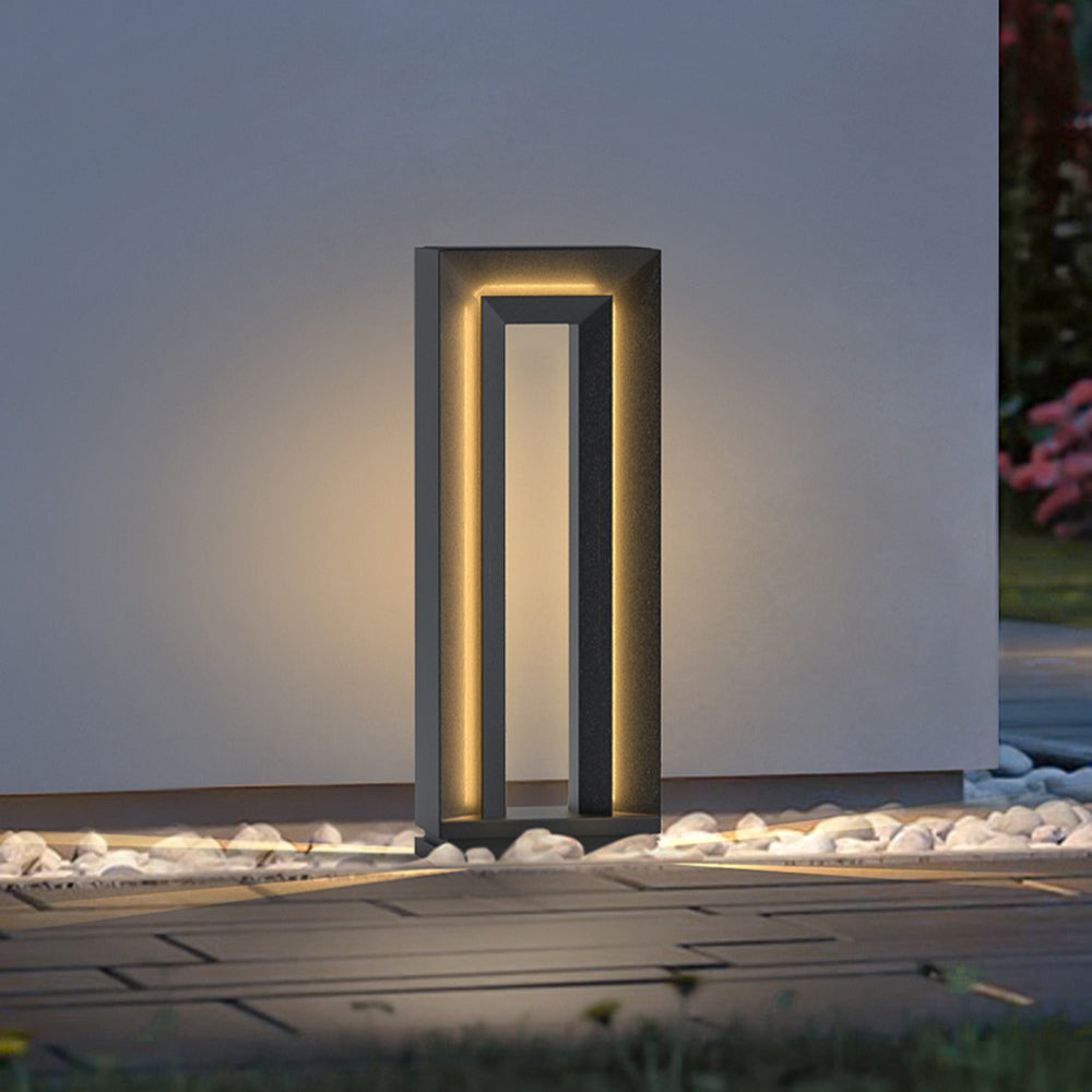 Pena Modern Metal Hollow Outdoor Path Light illuminating at night