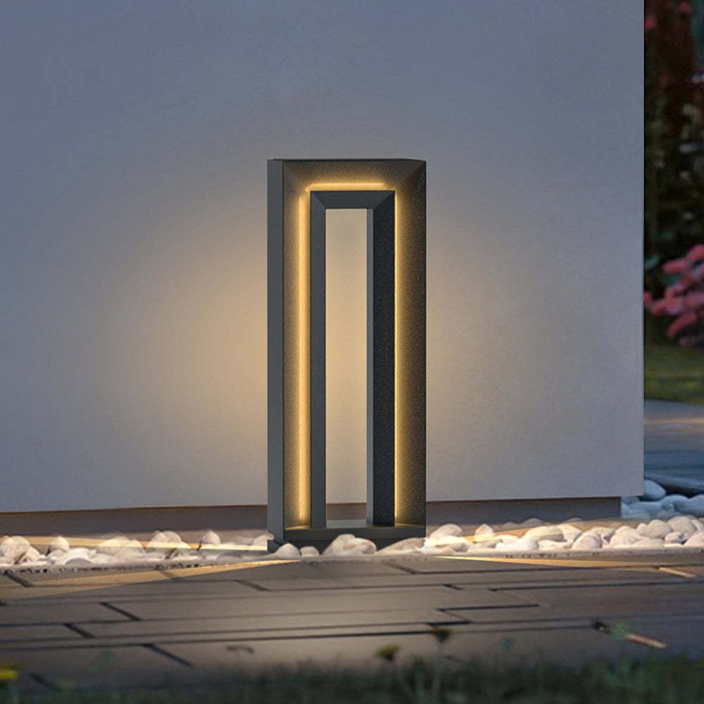 Pena Modern Metal Hollow Outdoor Path Light illuminating at night