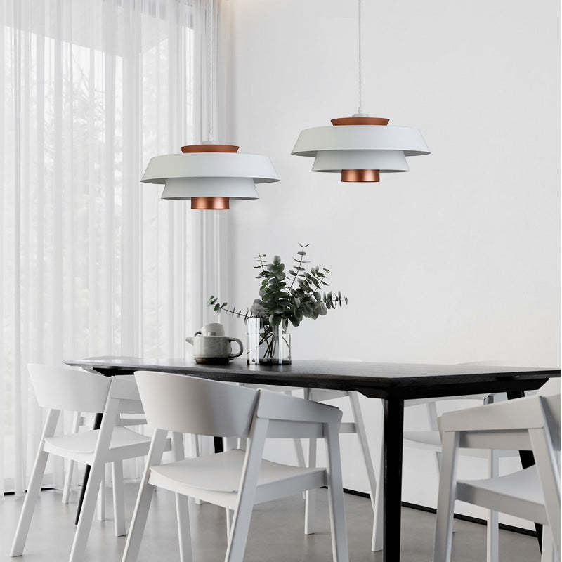 Modern dining room with white chairs and Hailie Nordic pendant lights