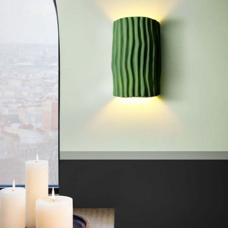 Green Morandi Resin Wall Lamp on wall, candles, and city view