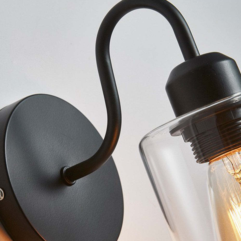 Alessio wall lamp: glass shade and metal base.