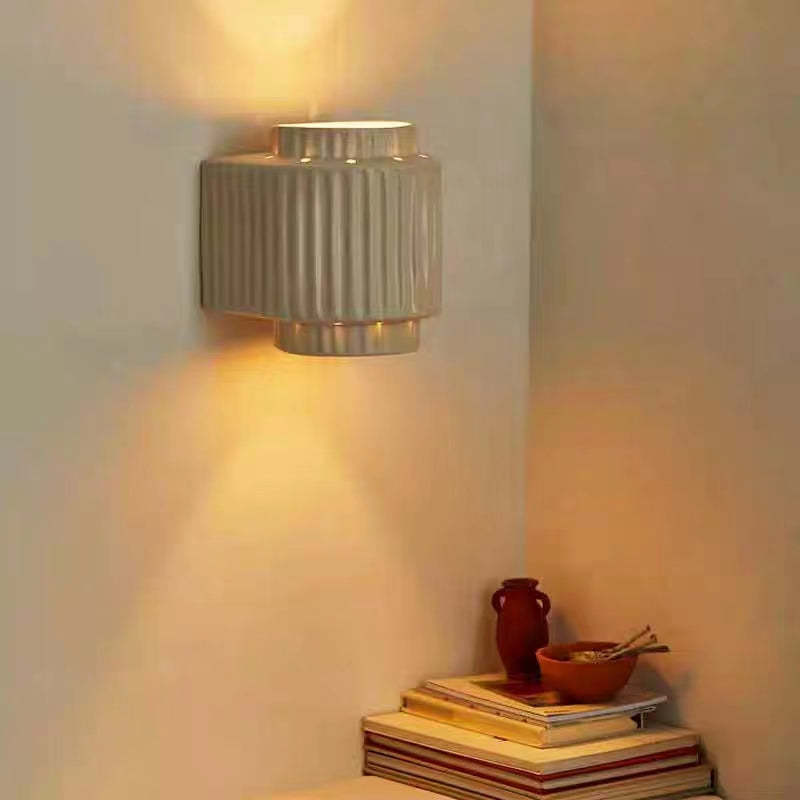 Cylindrique Resin Wall Lamp illuminating a bedroom corner