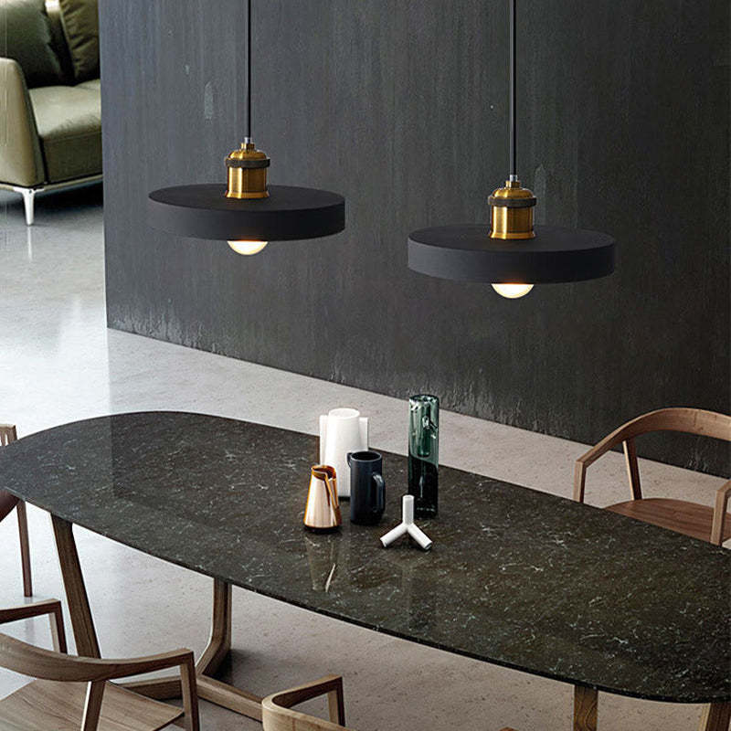 Black Morandi pendant lights above a dining table