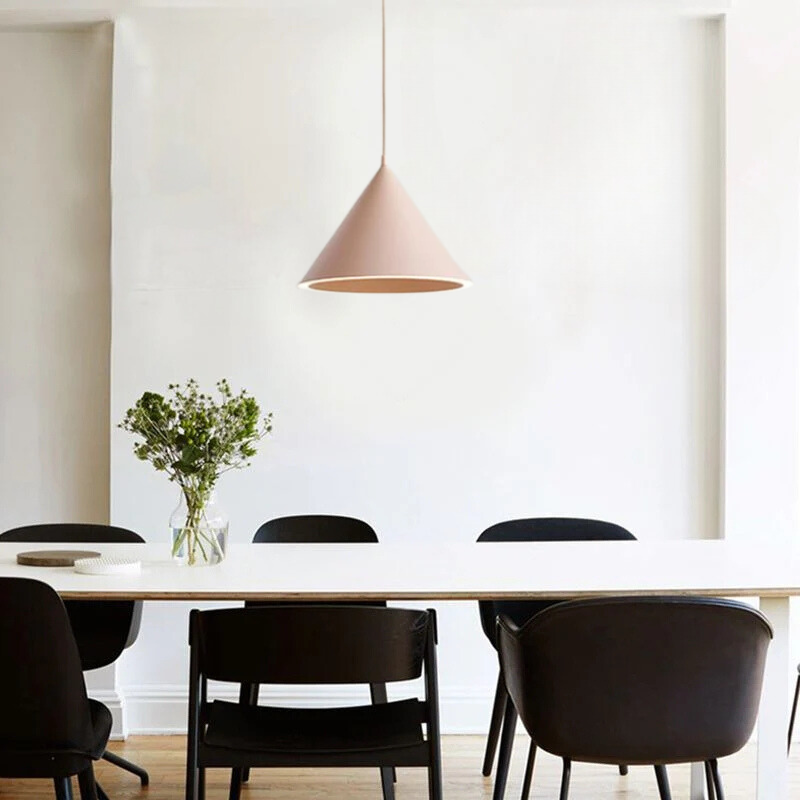 Pink Morandi pendant light above dining table. Artistic lighting.