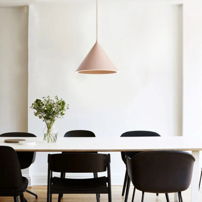 Pink Morandi pendant light above dining table. Artistic lighting.