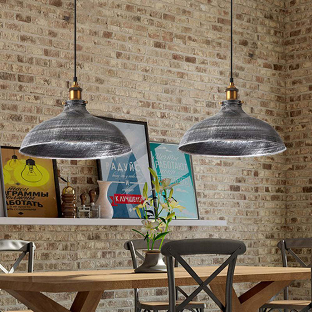 Distressed metal pendant lights in dining room