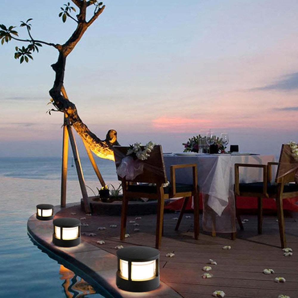 Pena outdoor bollard lights illuminating an outdoor dining area at sunset