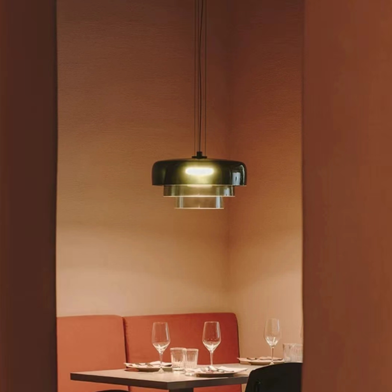 Morandi green pendant light above a dining table setting