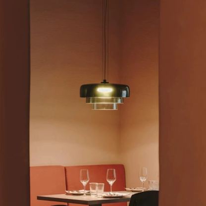 Morandi green pendant light above a dining table setting