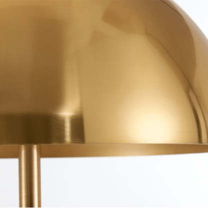 Gold shade of metal tripod floor lamp