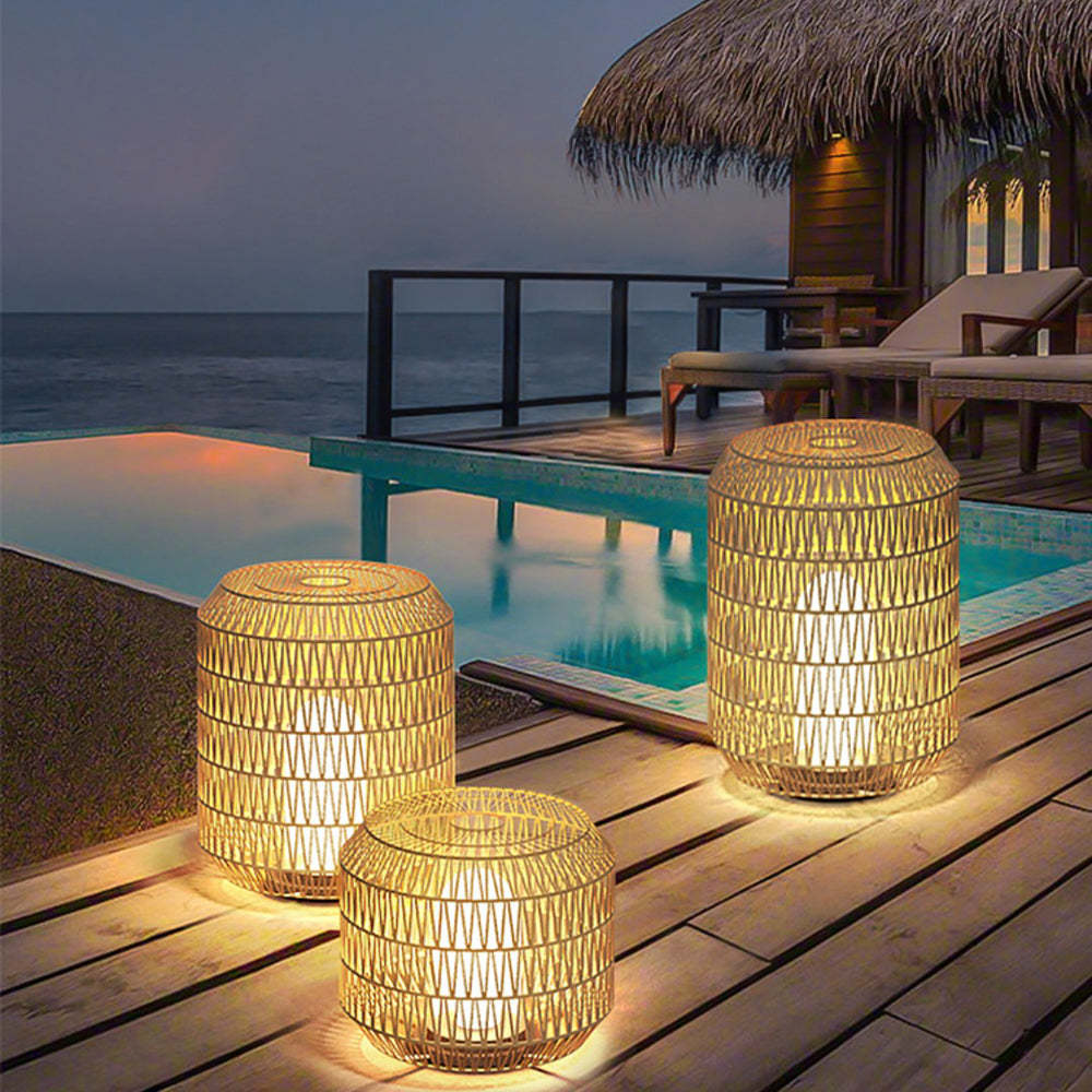 Ritta Rattan Outdoor Floor Lamps illuminating patio at night