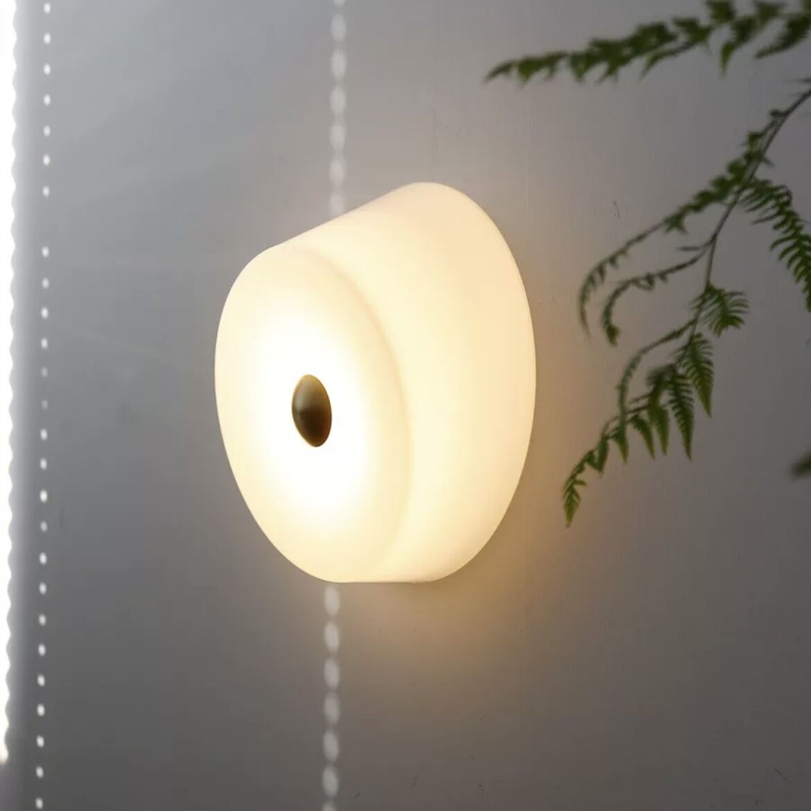 Orr Modern Wall Light on wall, illuminating room