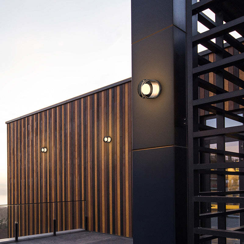 Outdoor wall lamp illuminating exterior, wooden wall and metal structure