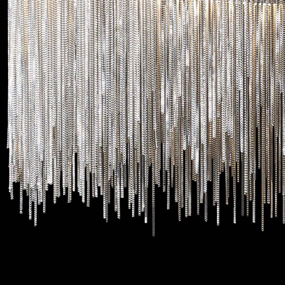 Close-up of Colon wall lamp silver metal chain detail.