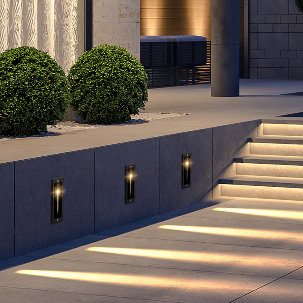 Modern gray outdoor step lights illuminating walkway