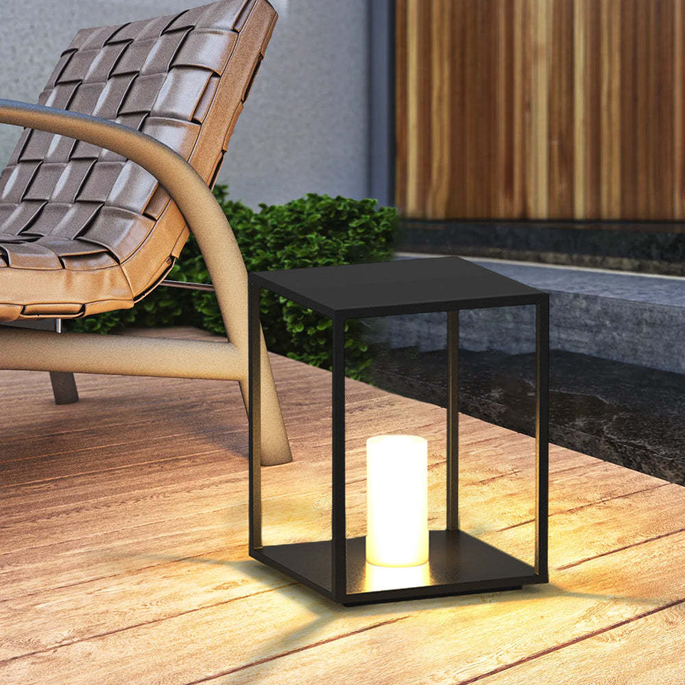 Black Pena outdoor bollard lamp illuminating a garden setting