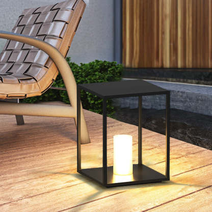 Black Pena outdoor bollard lamp illuminating a garden setting