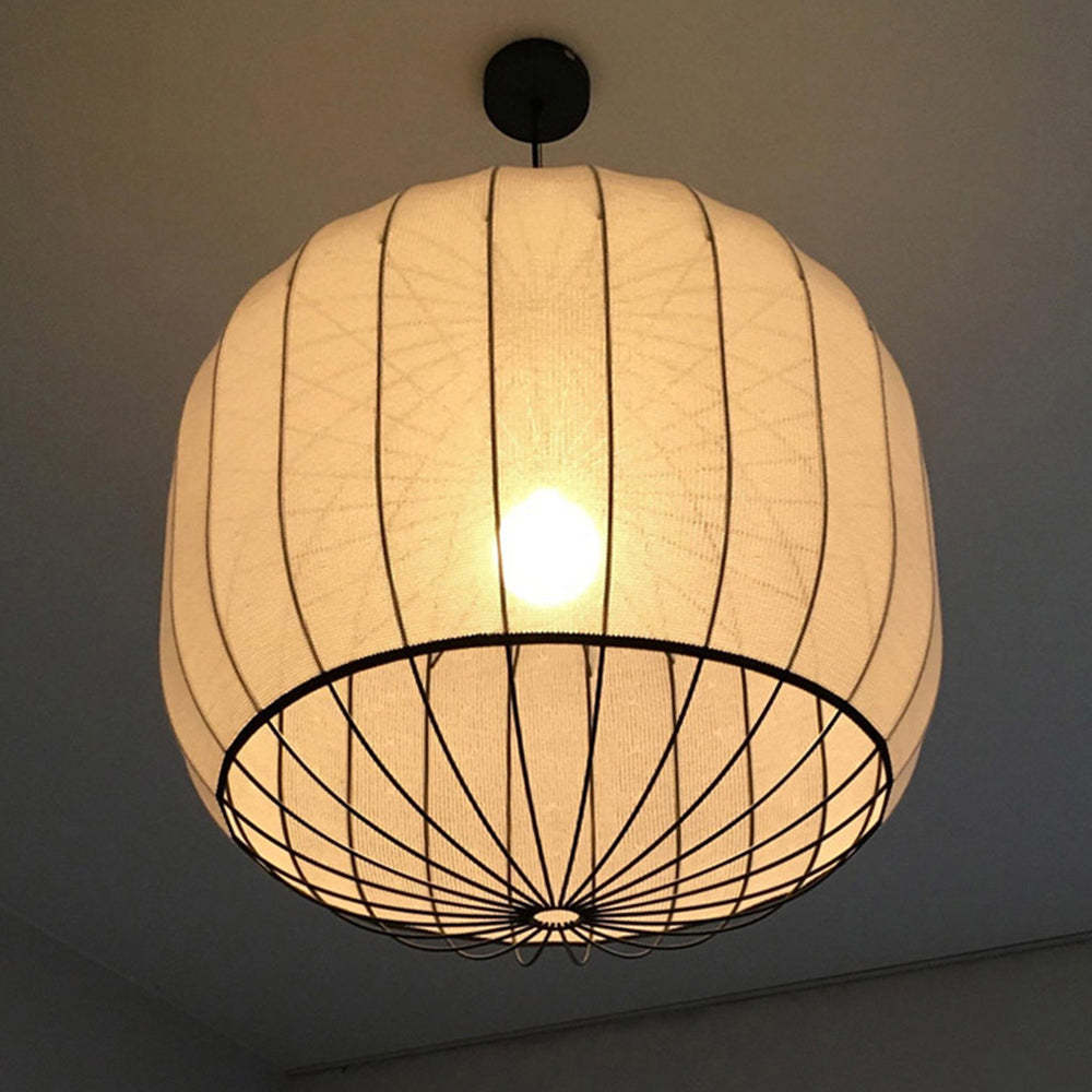 Renée pendant light with fabric shade, illuminating warmly