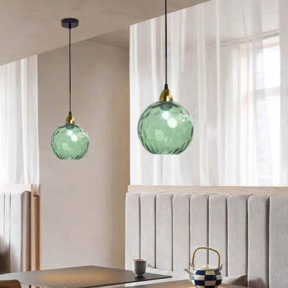 Green Hailie glass pendant lights in a dining room