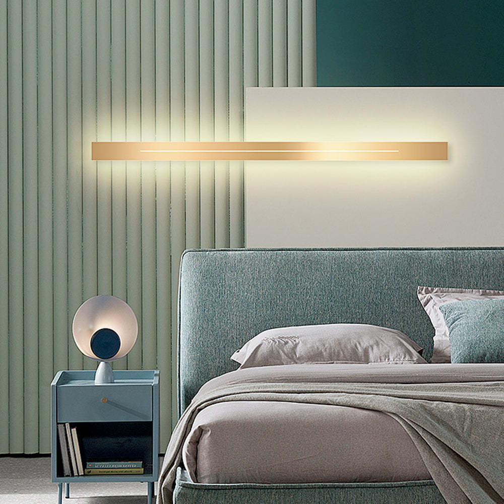 Modern gold LED wall lamp in bedroom, Lassola lighting