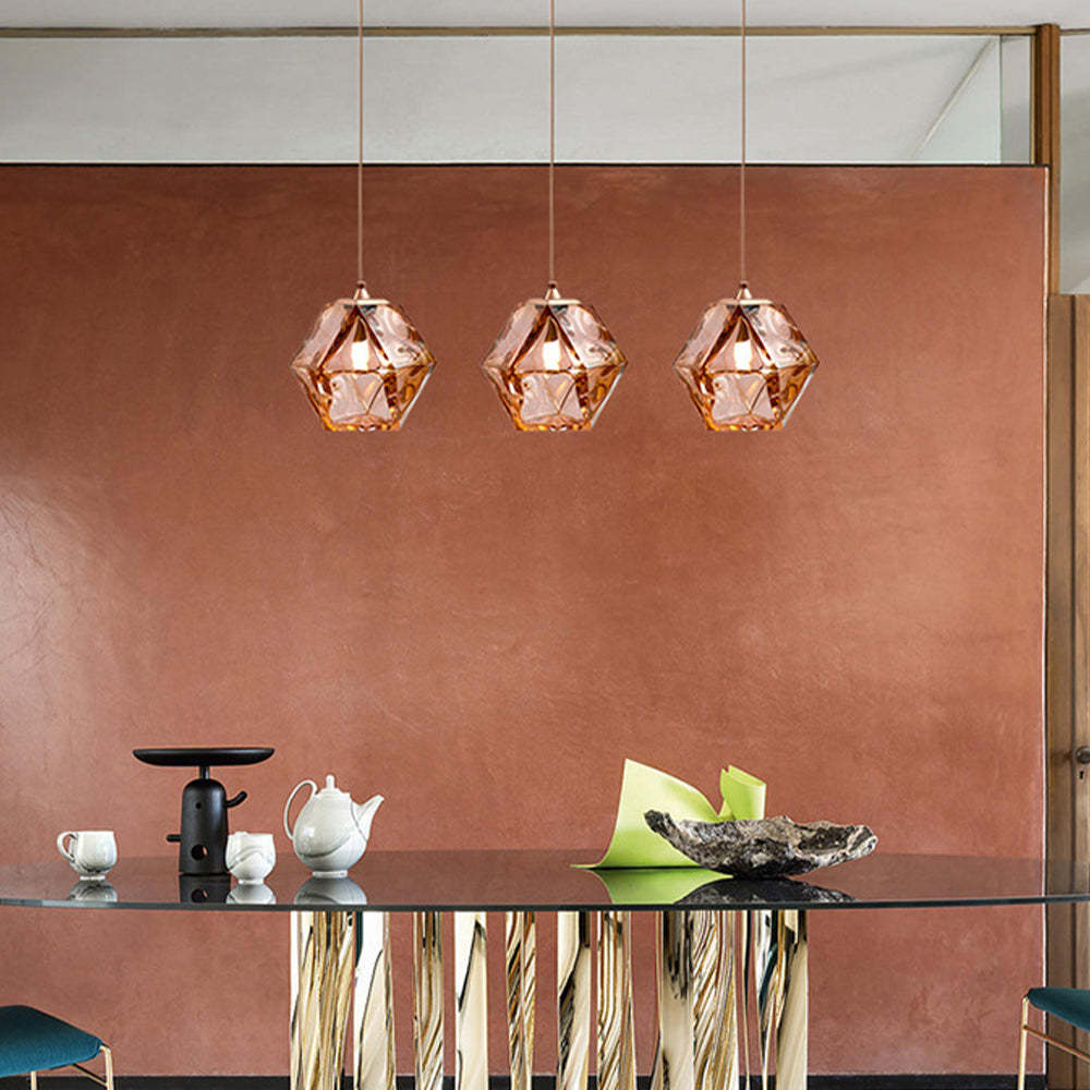 Rose gold Hailie Polyhedron pendant lights over a dining table