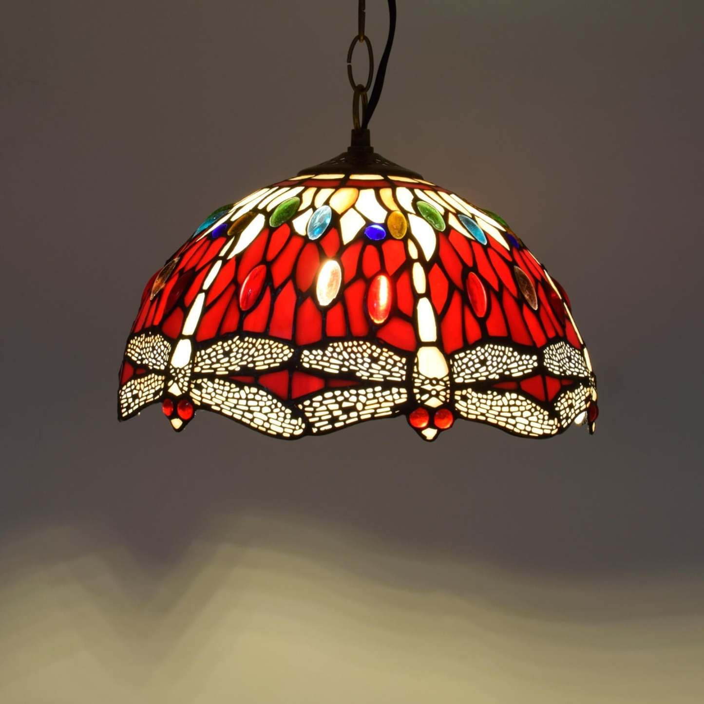 Red glass pendant light with dragonfly design