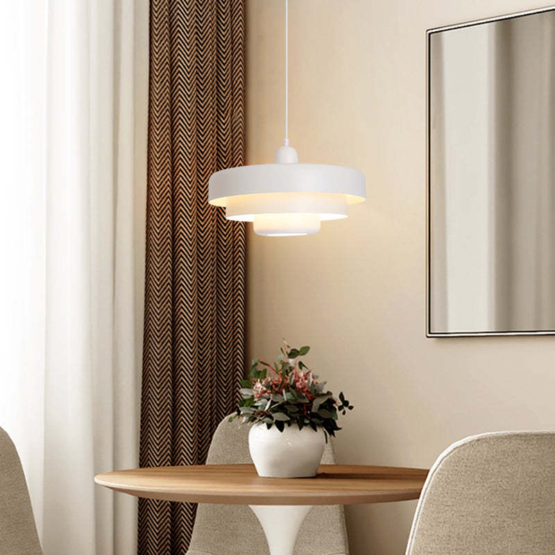 White Morandi pendant light over dining table in living room.