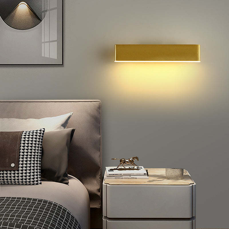 Aqsa gold metal rotatable wall lamp in bedroom setting.