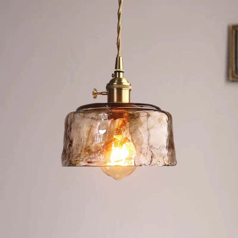 Levy industrial pendant light with caramel glass.