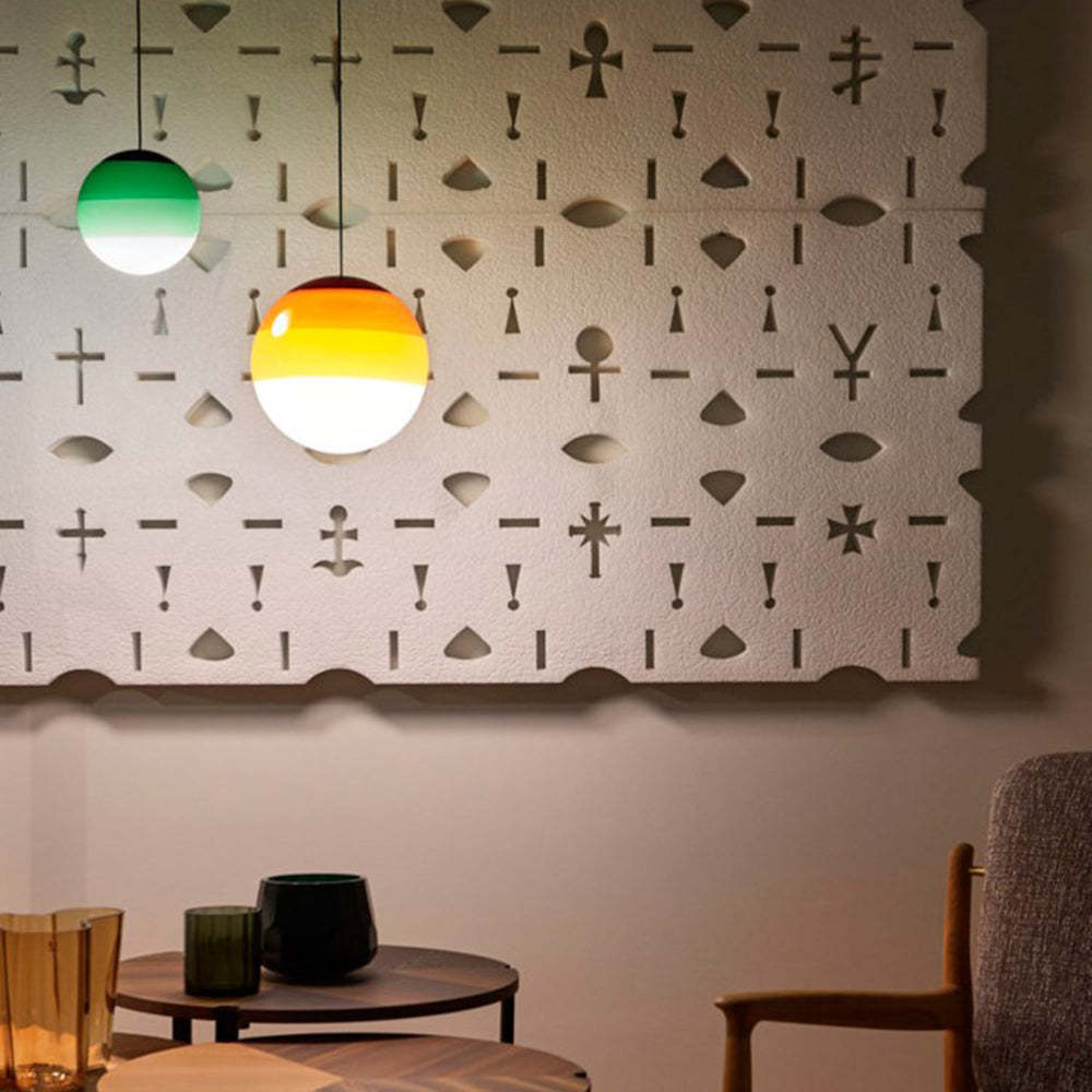 Glass bubble pendant lights in green and orange hues.
