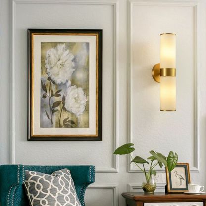 Leigh brass wall lamp next to flower painting in living room