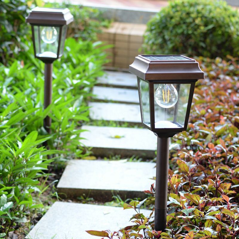 Outdoor solar bollard lights illuminating garden pathway