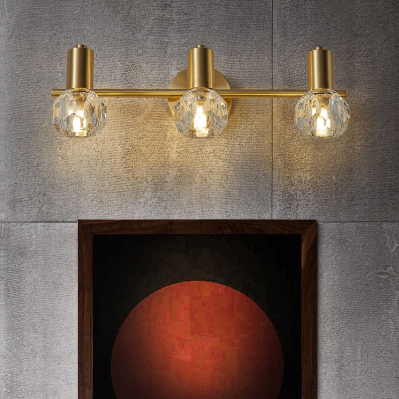 Kristy 3-light vanity wall lamp, gold finish, crystal globe shades