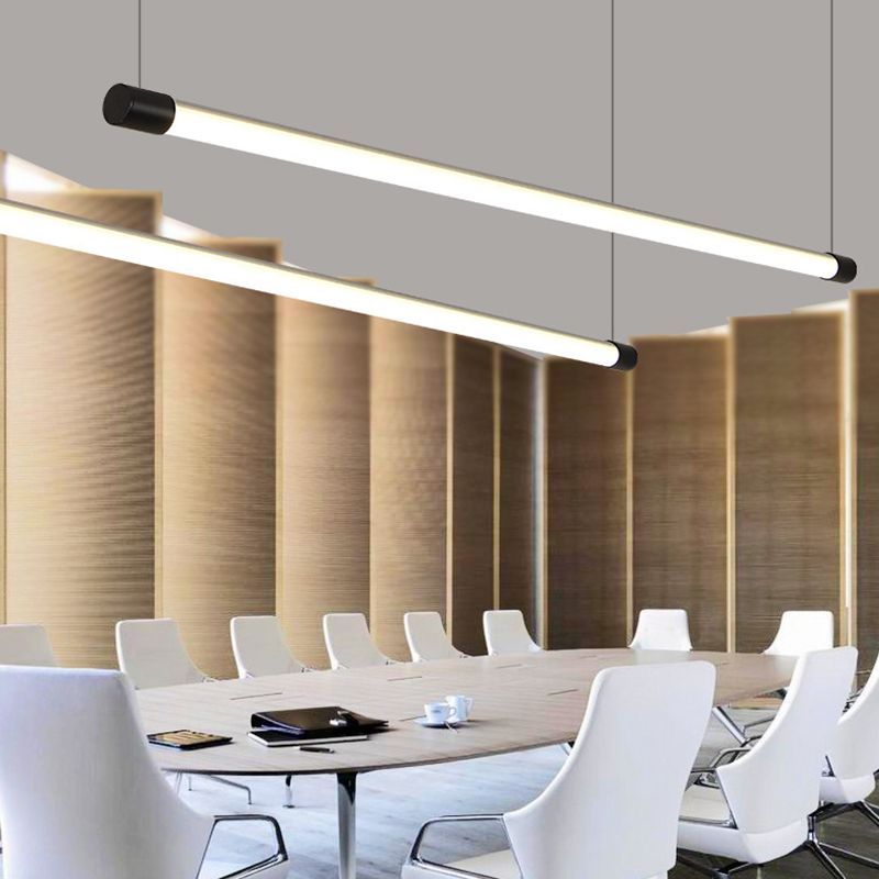 Linear LED pendant light above conference table.