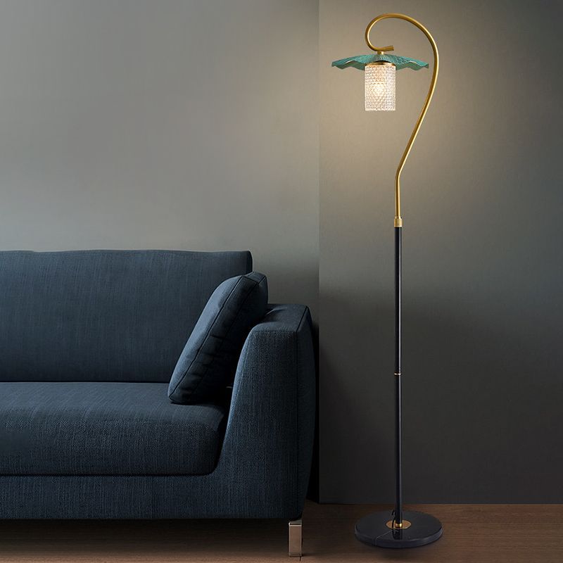 Carins Lotus-shaped Floor Lamp beside a sofa, green lampshade