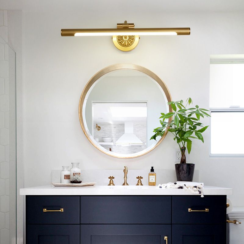 Modern gold vanity light above bathroom mirror