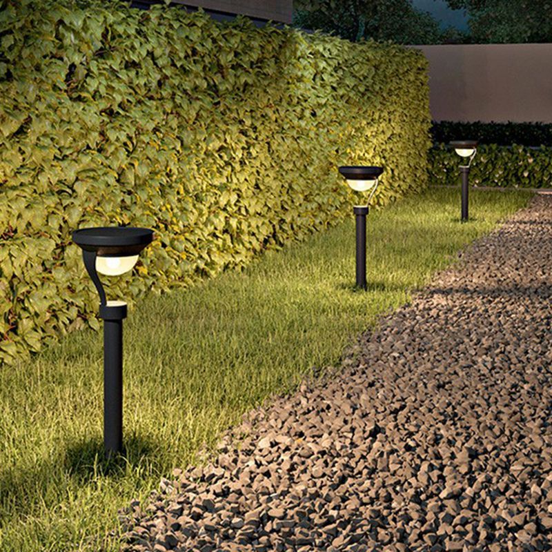 Outdoor solar bollard lights illuminating garden pathway
