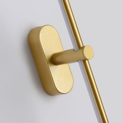 Gold Leigh minimalist wall lamp. Modern lighting detail.
