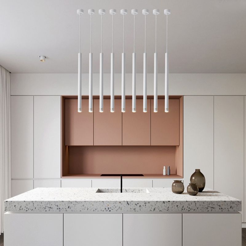 Minimalist cylinder pendant lights in modern white kitchen